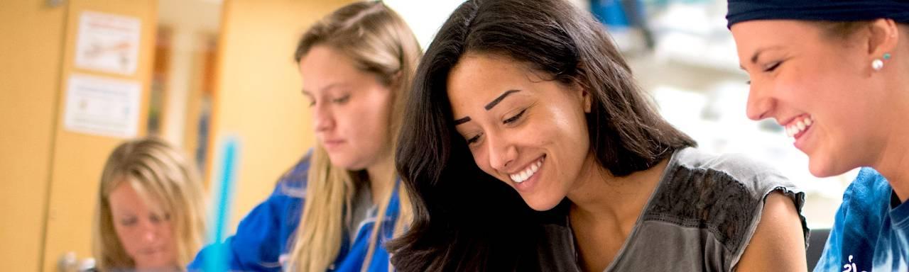 GVSU female students working together at a table